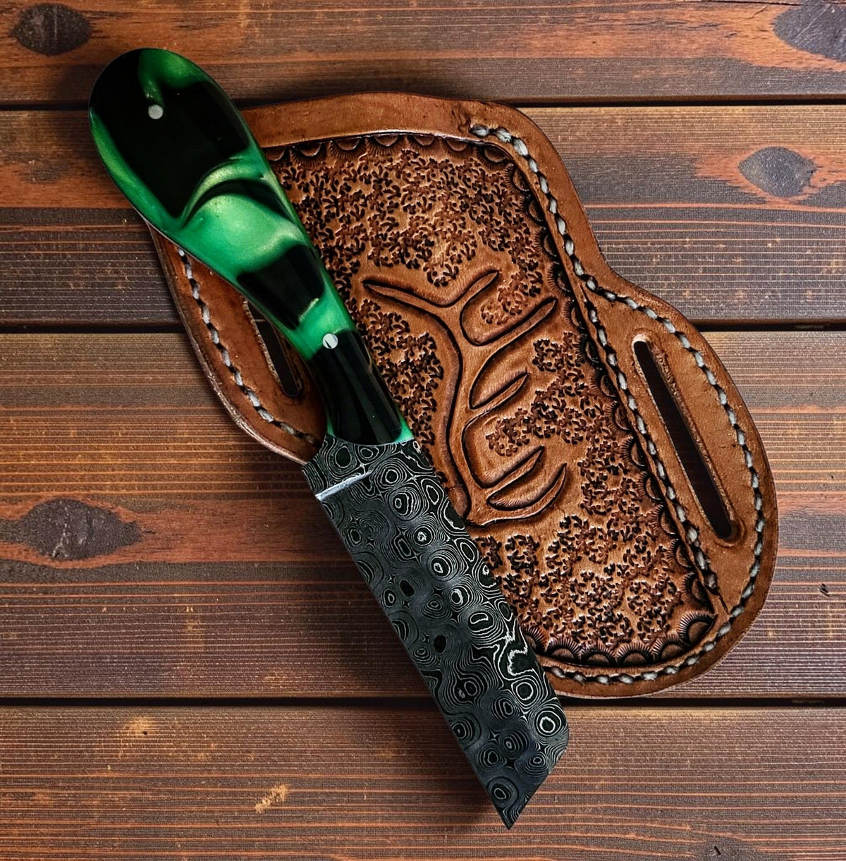 The Prairie Fire custom handmade Damascus steel bull cutter knife with epoxy resin handle and leather sheath